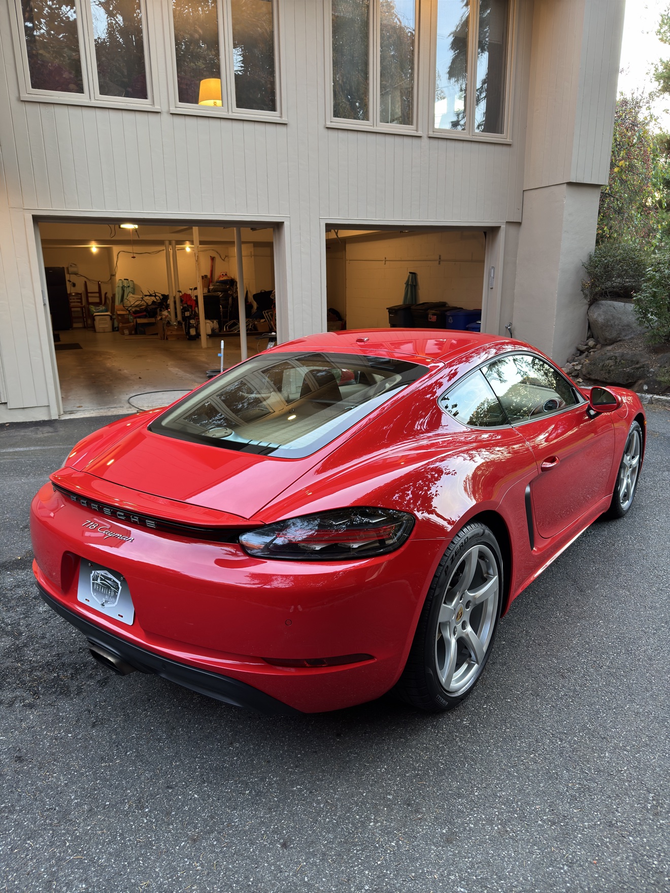 Red Porsche 718 Cayman rear angle view after detailing