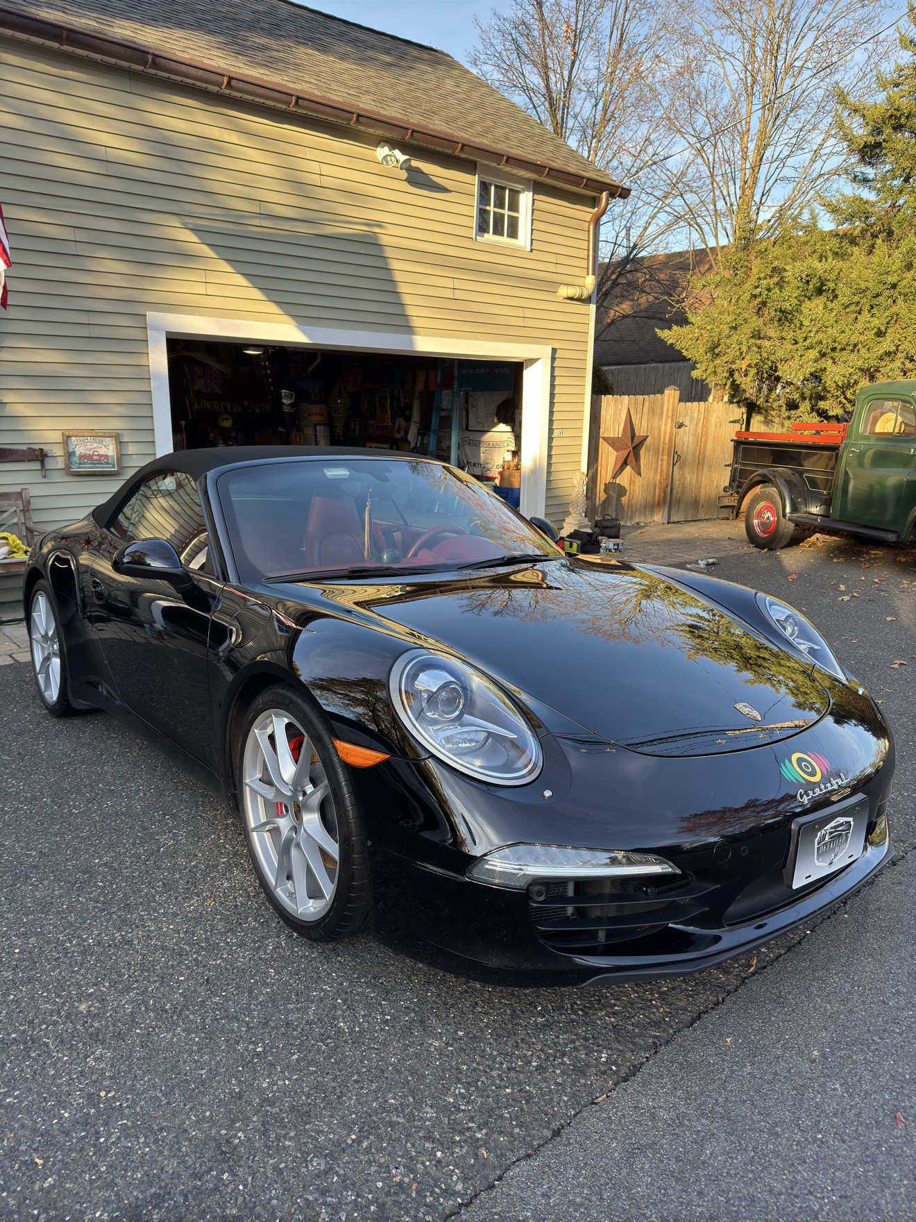 Black Porsche 911 Carrera S convertible front three-quarter view after detailing