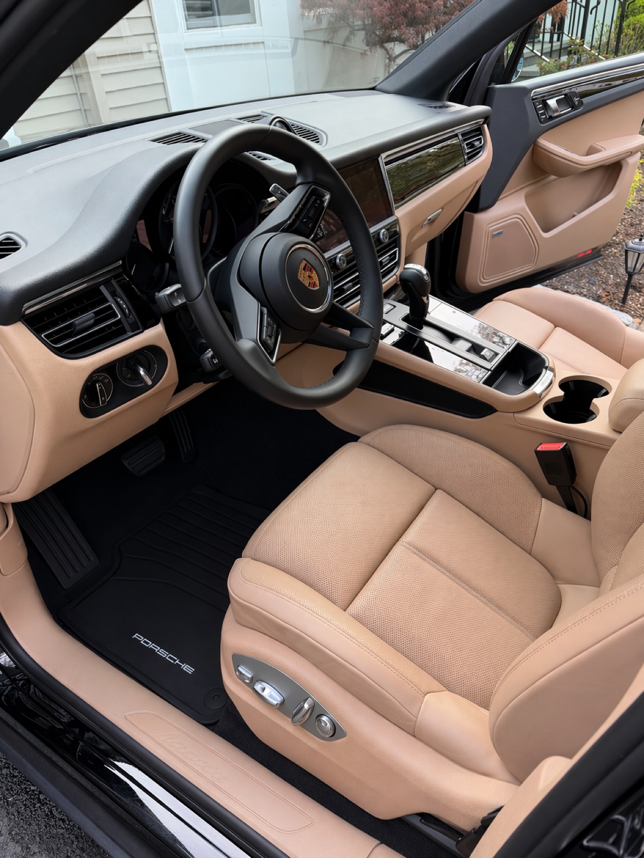 Porsche Macan driver interior with beige leather seats and Macan sill plate