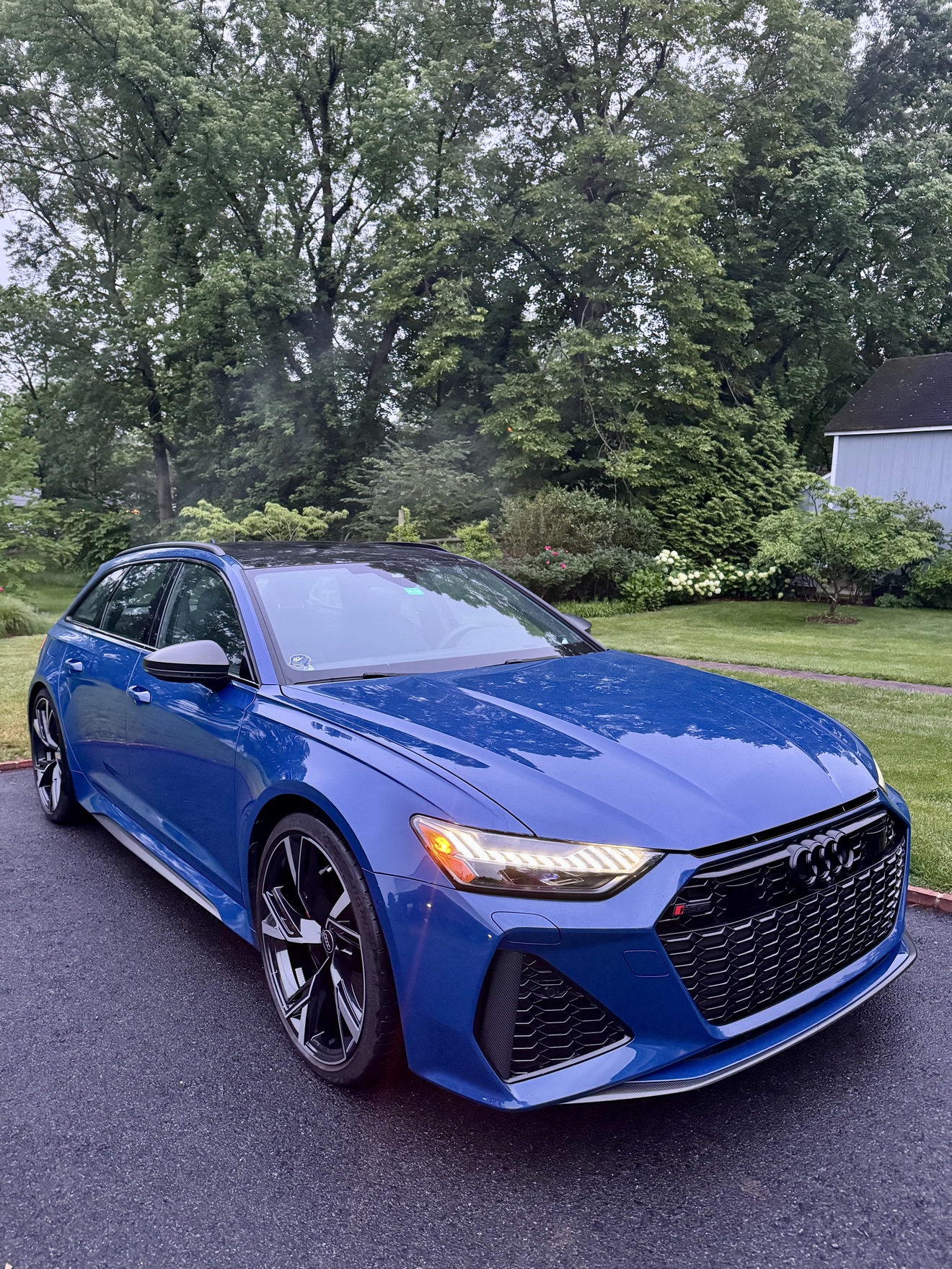 Blue Audi RS6 Avant front three-quarter view in a driveway after detailing