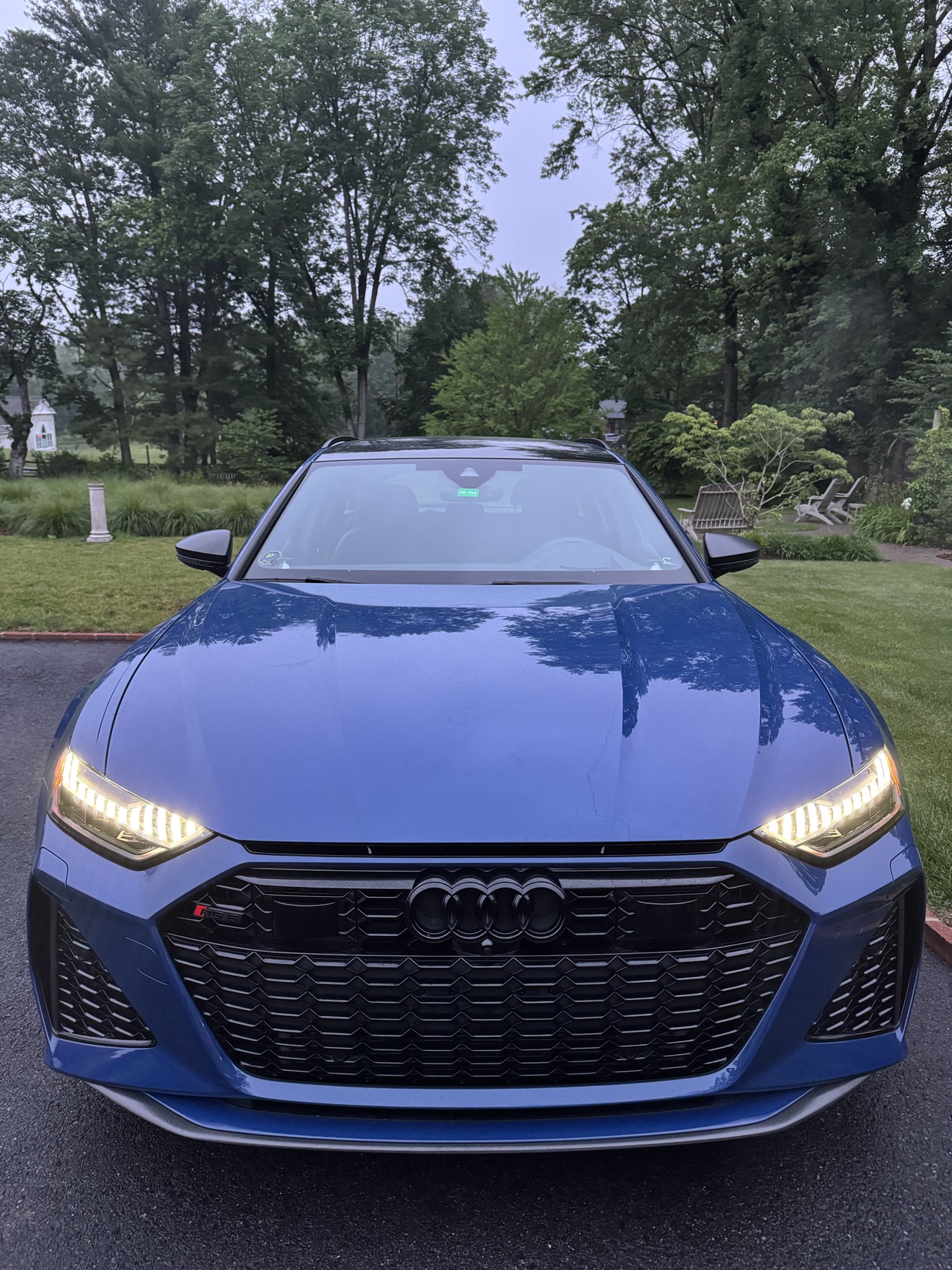 Front view of a blue Audi RS6 Avant with LED daytime running lights