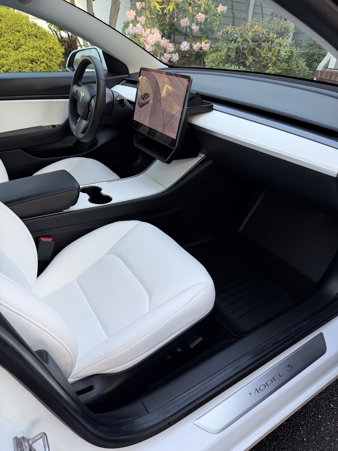 Tesla Model 3 passenger cockpit with white seats and Model 3 sill plate