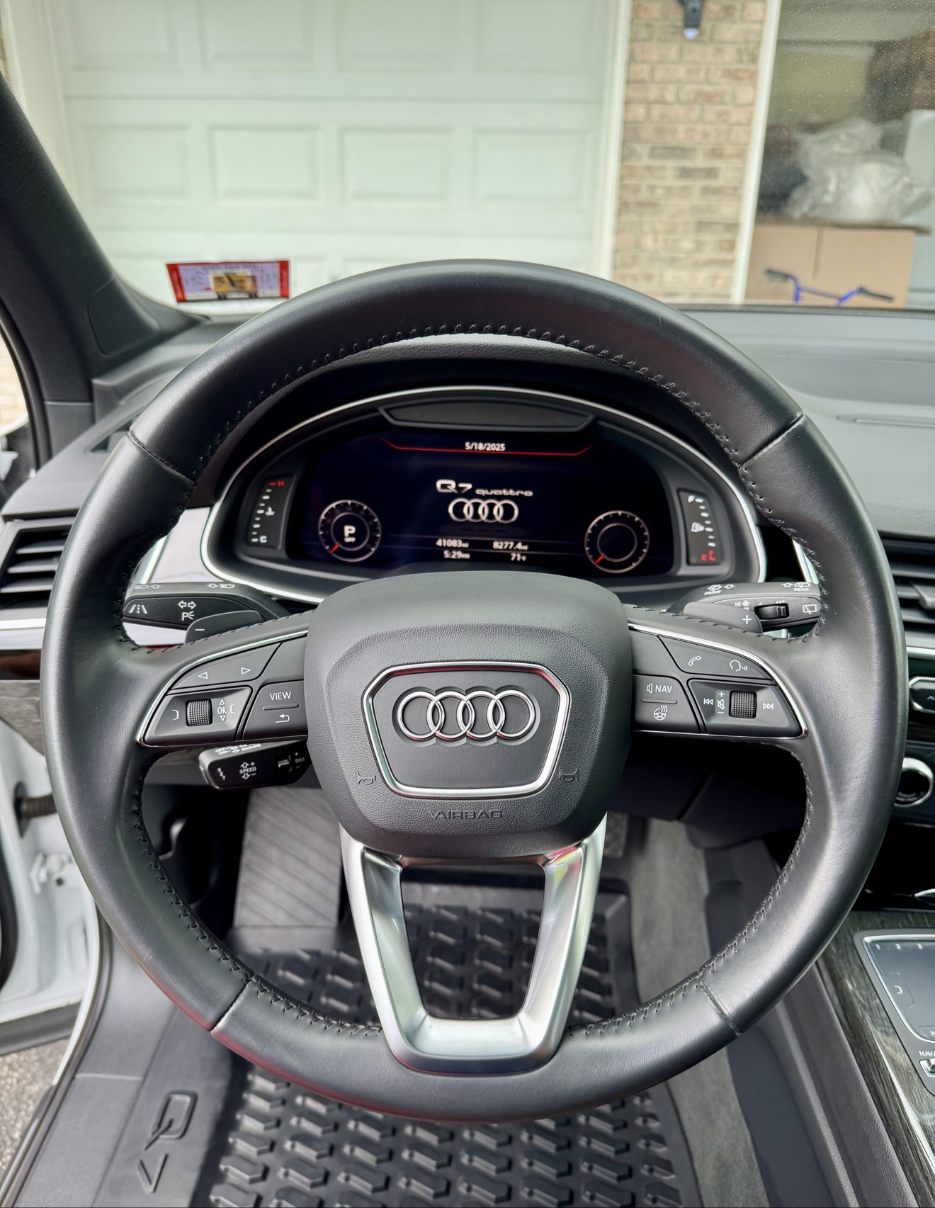 Close-up of the steering wheel in an Audi Q7 with digital gauges