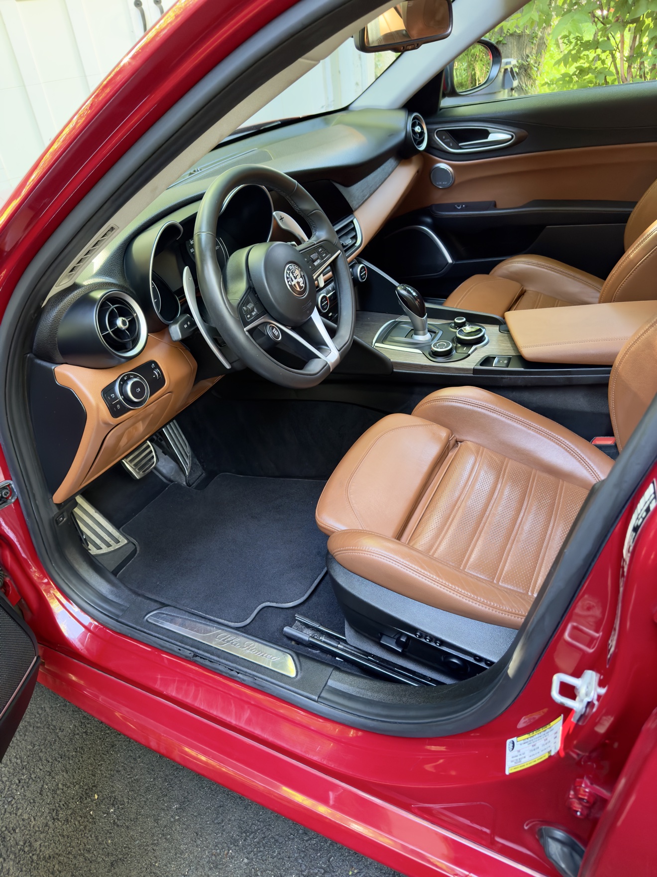 Alfa Romeo Giulia Q4 driver cockpit with tan leather seats after detailing