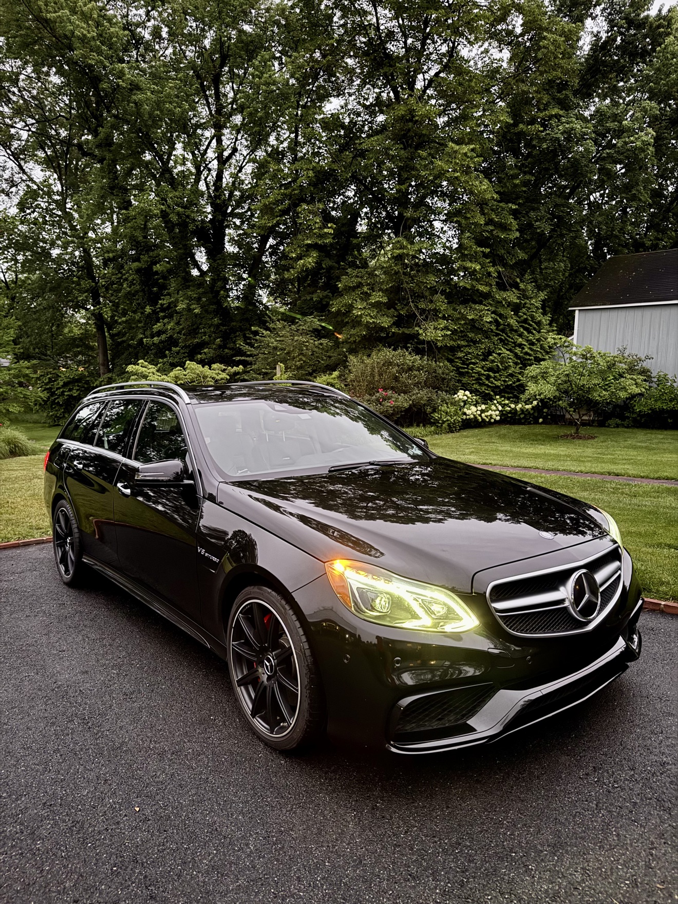 Black Mercedes Benz E63 S AMG wagon front three-quarter view after detailing