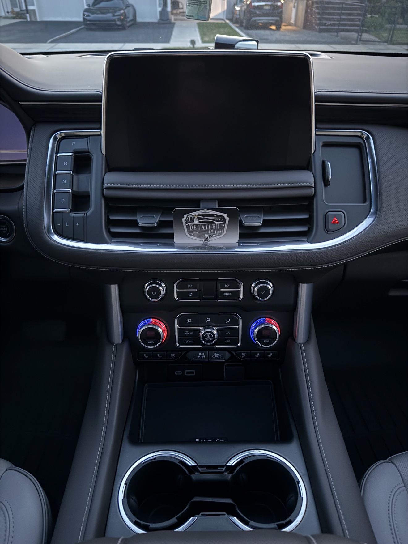 GMC Yukon SLT center console with Detailed by Yael business card