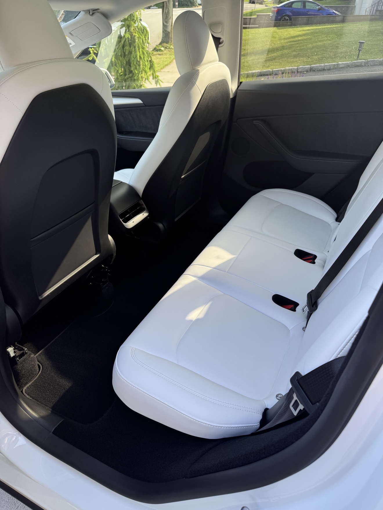 Tesla Model Y rear seats in white leather after detailing