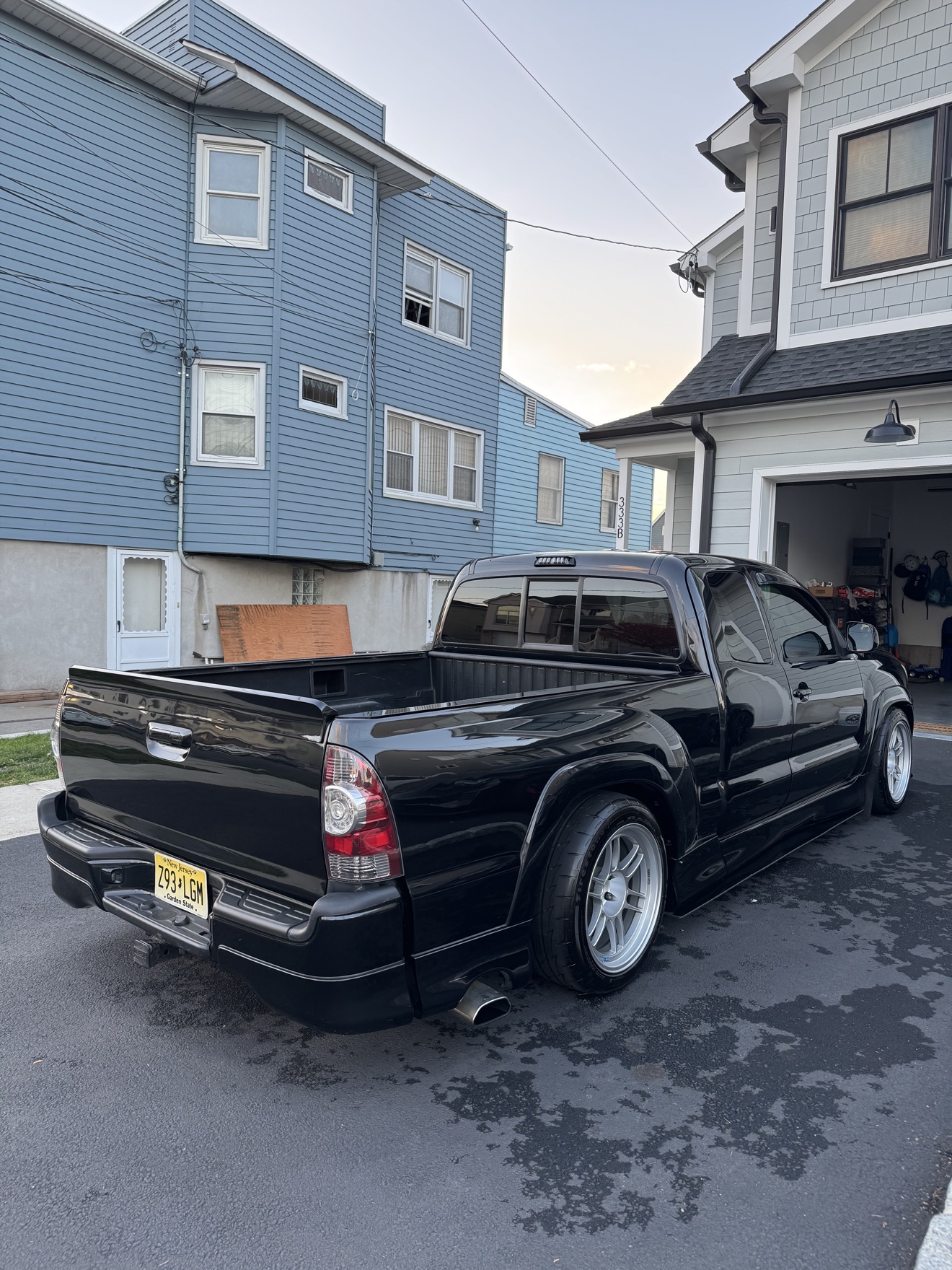 Black Toyota Tacoma X-Runner rear angle view with lowered stance after detailing