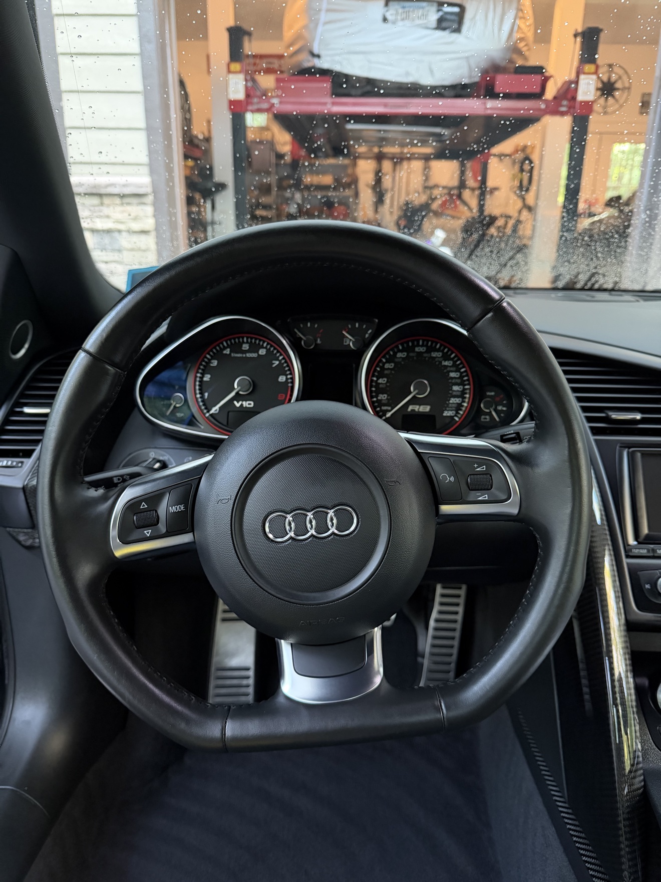 Close-up of the steering wheel and V10 gauges in an Audi R8 Spyder
