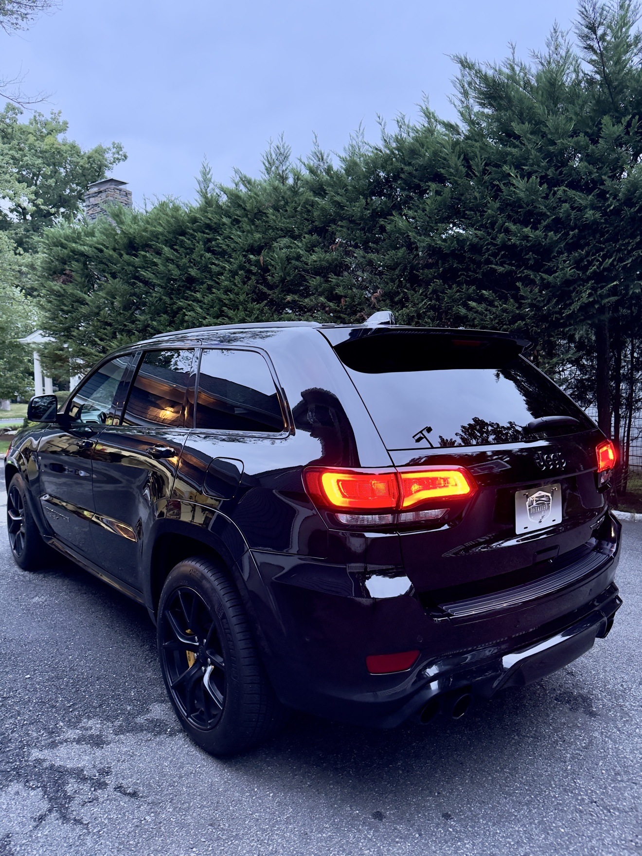 Black Jeep Grand Cherokee Trackhawk rear three-quarter view after detailing