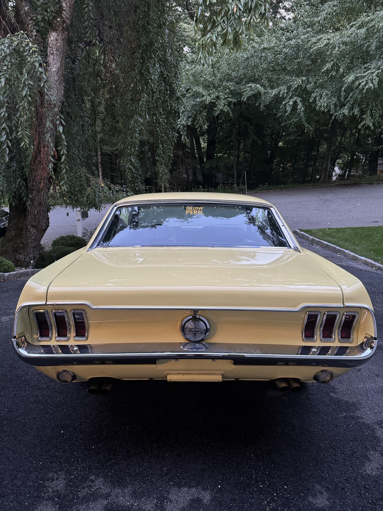 Rear view of a 1968 Ford Mustang with triple taillights and chrome trim
