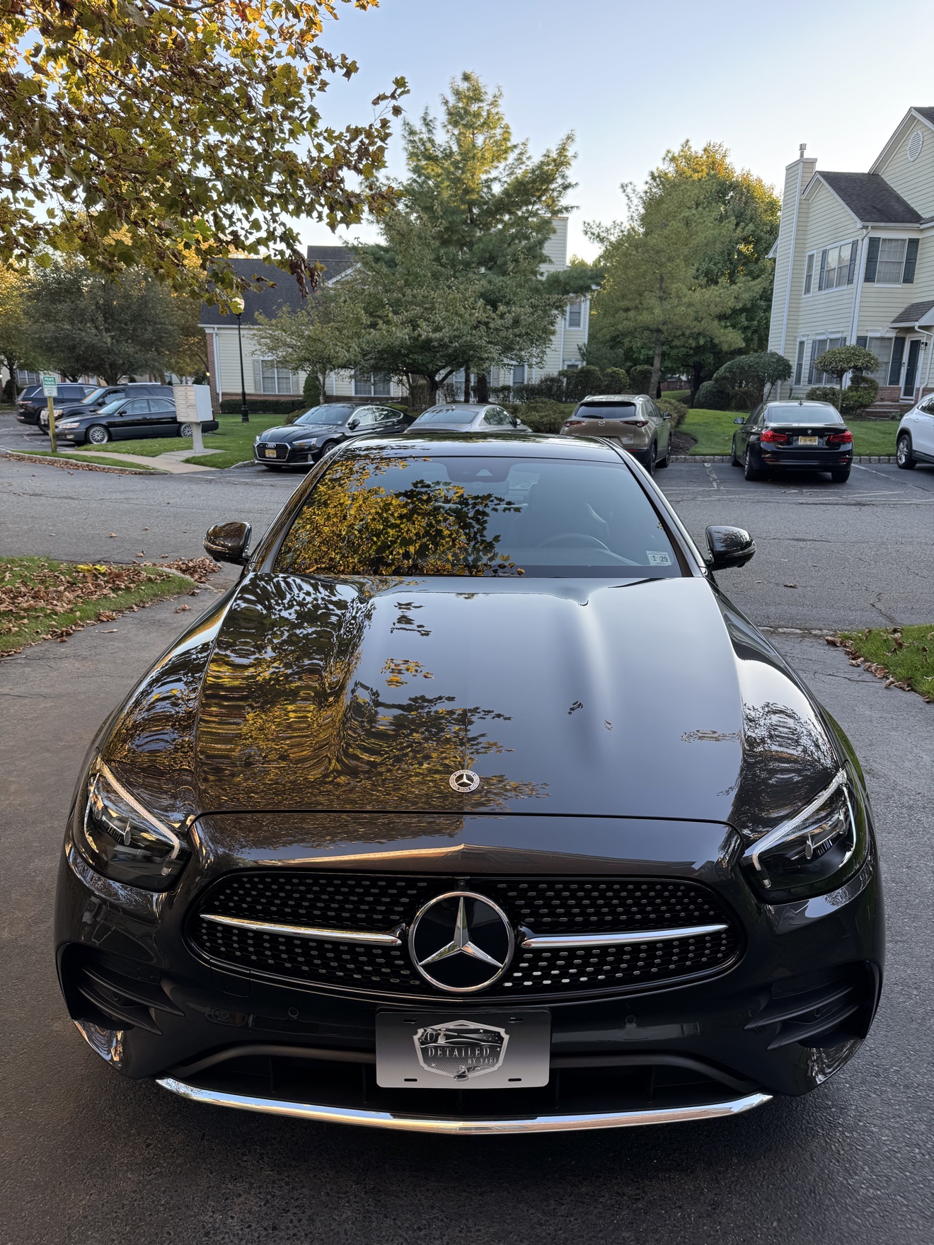 Black 2023 Mercedes-Benz E350 front view with Detailed by Yael plate frame